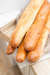 Freshly baked french baguettes on wooden box