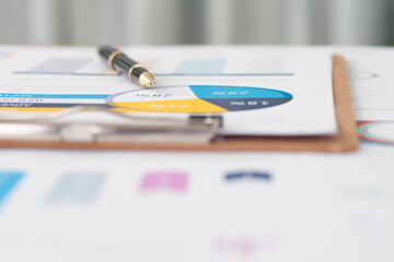 Close up of signature pen on financial materials