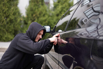 Car jacking thief steal car breaking door criminal job burglar Hijacks  Auto thief black balaclava...