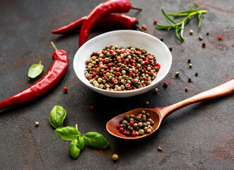 Red hot chili pepper corns and pods on dark  background, top view