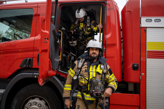 Firefighter in front of fire engine