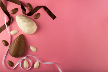 Easter. Composition with chocolate Easter eggs on pink background, space for text.