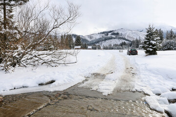 ZAKOPANE, POLAND - JANUARY 28, 2021: Banks of a mountain stream covered with snow, winter landscape.