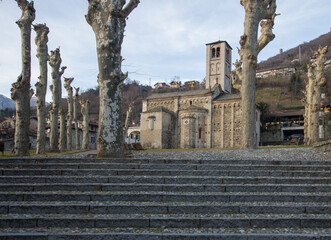 Fototapeta na wymiar access by long cobblestone staircase to an ancient Romanesque church.Como lago, italian lakes, Lombardy, Italy.
