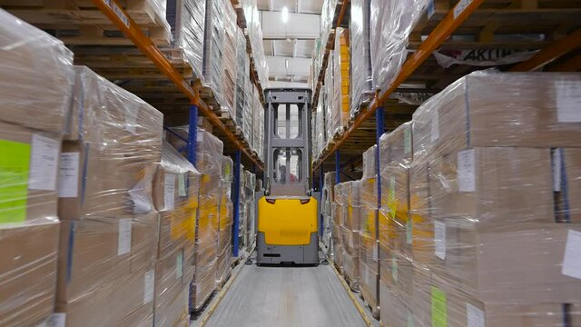 A huge warehouse filled with packed pallets. Logistics and storage of a large volume of goods.