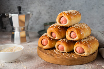 Homemade sausages in dough on a wooden board, fast food