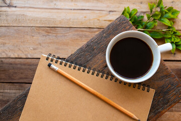 notebook planner for business work with hot coffee arrangement flat lay style on background wooden