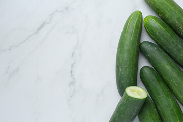 fresh cucumbers sliced on marble background