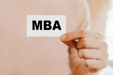 Man holding a business card with MBA