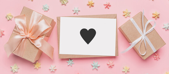 Gifts with note letter on isolated pink background with sweets, love and valentine concept with heart