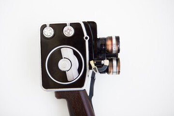 Motion picture camera on the white background. Vintage black ginder