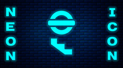 Glowing neon London underground icon isolated on brick wall background. Vector.