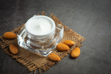 Obraz na płótnie Canvas body almond moisturizer on dark background
