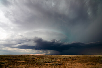 Supercell storm clouds over a field