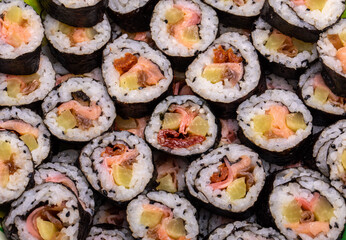 Top view of stack of Japanese sushi maki roll plate. Served in Japanese bar restaurant with chopstick