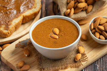 Raw Organic Almond Butter on dark wood background