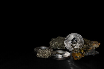 silver ether coins from ethereum currency and minerals bottom on black