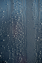 Water droplets on a blue color wall. Abstract texture and background