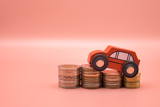 Red Toy Car On Pile Money Stack Coins Growth On Pink Background. Miniature Automobile Model And Business Finance Statement Vehicle Buy, Loan, Rent. Transportation Insurance Auto Care Industry Concept.