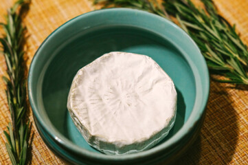 The brie cheese. Tasty camembert in a blue plate.