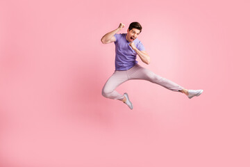 Fototapeta na wymiar Full size photo of young handsome man happy smile rejoice win victory jump isolated over pastel color background
