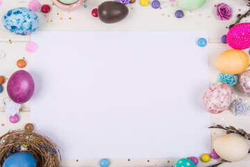 Naklejka na ściany i meble Colorful background with Easter eggs on white wooden board background. Happy Easter concept. Can be used as poster, background, holiday card