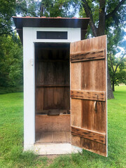 Colonial American outhouse with open door