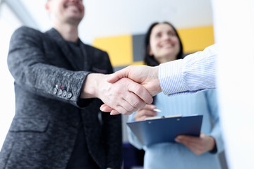 Closeup of business partners handshake in office - obrazy, fototapety, plakaty