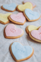 Fototapeta premium Valentine's Day presents: Heart-shaped cookies with colorful glaze and themed lettering for all lovers