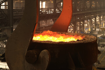 liquid molten steel in a bright red tank, similar to lava