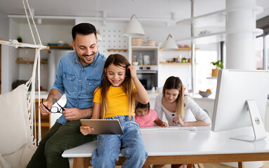 Parents helping to children studying online at home. Lockdown and online school, technology concept.