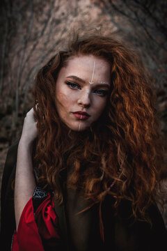 Red-haired Woman In A Red Dress In A Historical Celtic Costume In The Autumn Forest