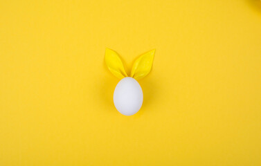 Egg with paper ears in the shape of an Easter bunny. Happy Easter Concept Card Postaer Background