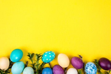 Colorful background with Easter eggs on yellow background. Happy Easter concept. Can be used as...