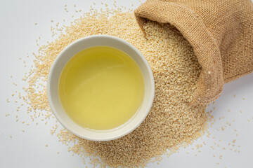Sesame oil and sesame seeds on marble background