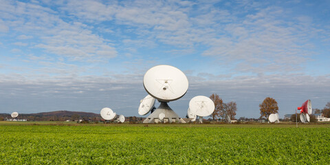 Satellite dishes of the Raisting Radome. With a green field in the foreground. Panorama format.