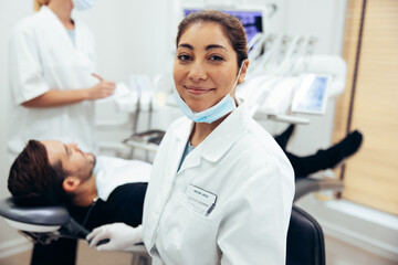 Happy female dentist in her clinic