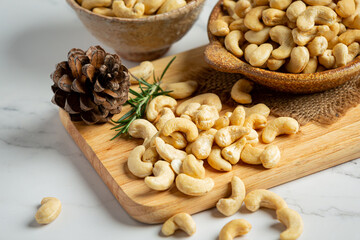 Raw cashews nuts in bowl on marble background