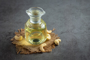 cashew nuts oil with cashew nuts on dark background