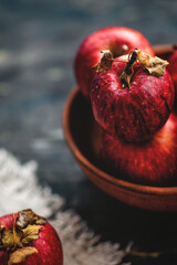 Fresh red apples on a plate on a wooden background. Red apples on a dark background. Selective focus