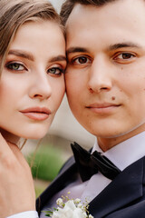 beautiful, gentle and happy bride and groom. man gently touches woman's face