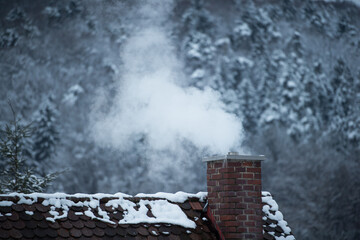 Smoking chimney in winter  - obrazy, fototapety, plakaty