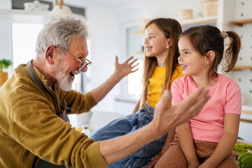Happy grandparent having fun times with kid at home