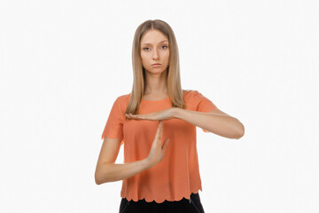 Fototapeta premium Young blond woman showing time out gesture. Human emotions, gesture concept. Studio shot, white background