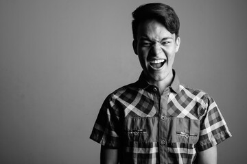 Portrait of young handsome Asian teenage boy