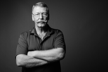 Portrait of handsome senior man with mustache wearing eyeglasses