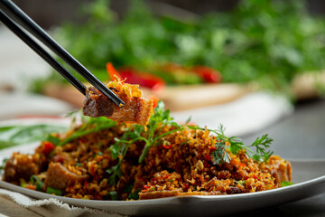 Fried Pork with Dried Chili and Salt on dark background