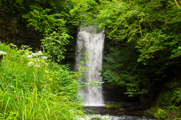 Fototapeta na wymiar 23 August 2019. The small fast running river at the Glencar waterfall site. The glen and falls is a favourite place for country walks.