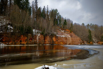 red sand stone by river