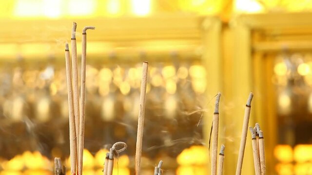 joss sticks are burning in temple , Wat Hariphuchai Lumphun province Thailand.